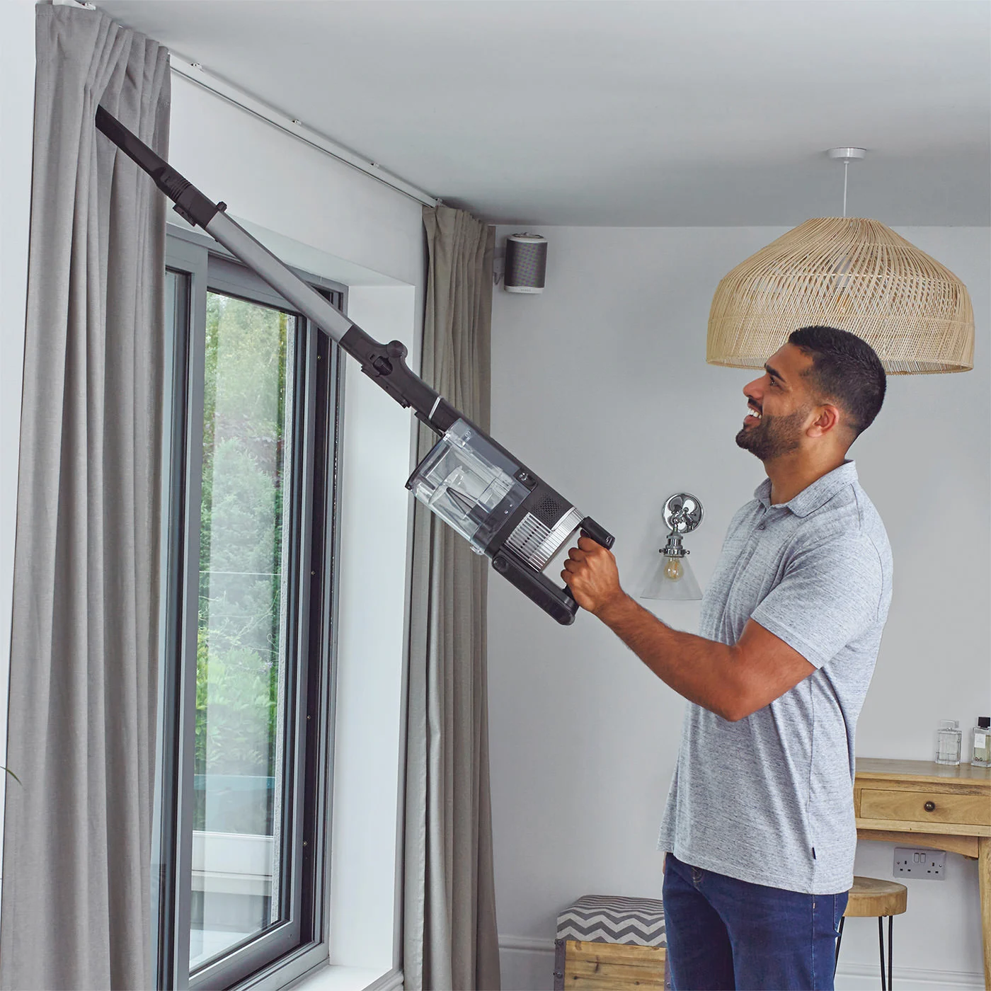 Shark-IZ420UKT-In-Use-Living-Room-Crevice-Tool-Reach-Man_copy